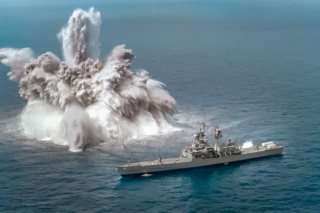 An explosive charge is detonated off the starboard side of the nuclear-powered guided missile cruiser USS ARKANSAS (CGN-41) during a shock test.